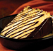 Our famous Boston cream pie smothered in brandy butter, drizzled with chocolate sauce and baked to perfection.